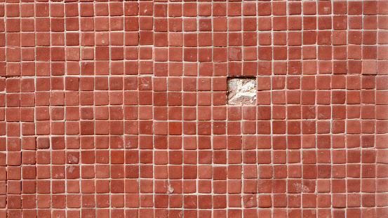 Gap in red square tile wall