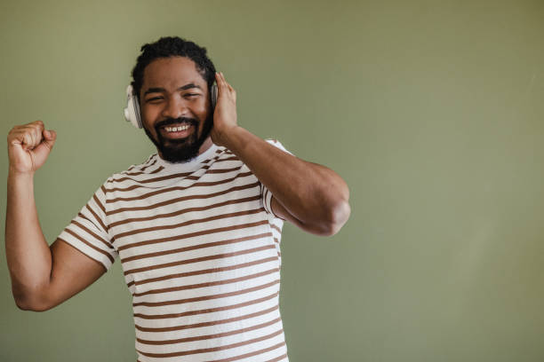 istock Young man dancing while listening music 1385982323