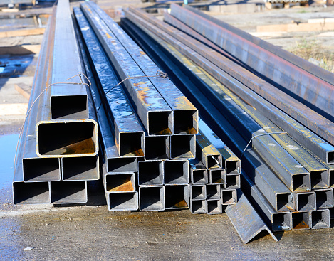 A pack of rectangular metal pipe outdoors. High quality photo