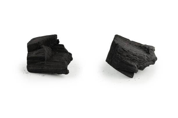 istock Black oak coal isolated on white background. 1385983489