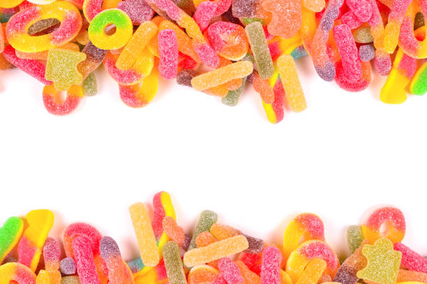 istock Frame of assorted gummy candies isolated on white. Top view. Space for text or design. 1385983499