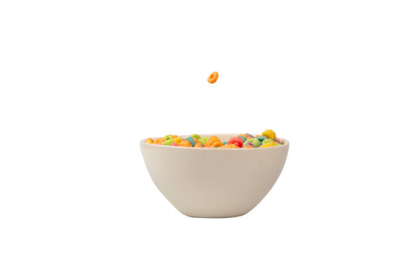 istock Colorful cereal box for morning breakfast. Corn flakes falling to the white bowl. Motion. 1385983505