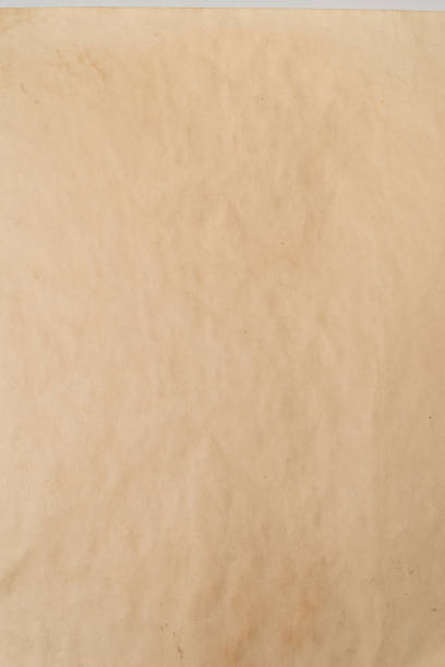 istock Old crumpled beige paper background. 1385983525