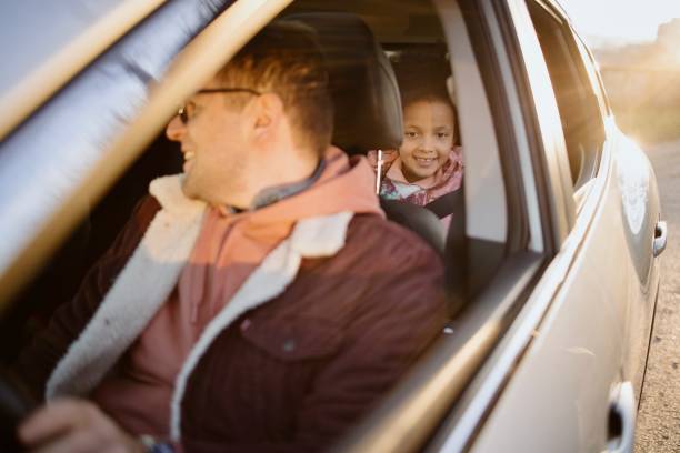 istock Parents And Daughter Enjoying Auto Ride Together On Weekend 1385985321
