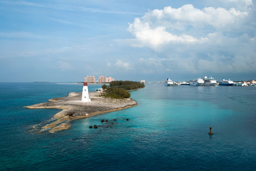 The aerial view of a lighthouse on a tip of Paradise Island and cruise ships moored in Nassau Harbour (Bahamas).