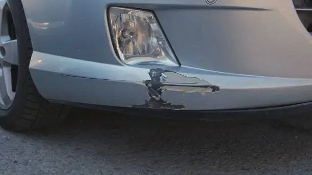 Car Bumper Damaged and Scratched in Collision on Parking Lot