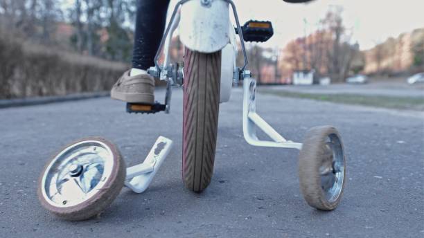 istock Young Kid Learning To Ride a Bike without Support Stabilizer Wheels Left Behind 1385995561