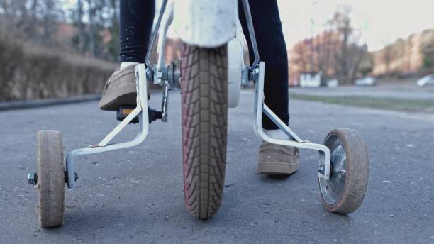 istock Young Kid Learning To Ride a Bike without Support Stabilizer Wheels Left Behind 1385995562
