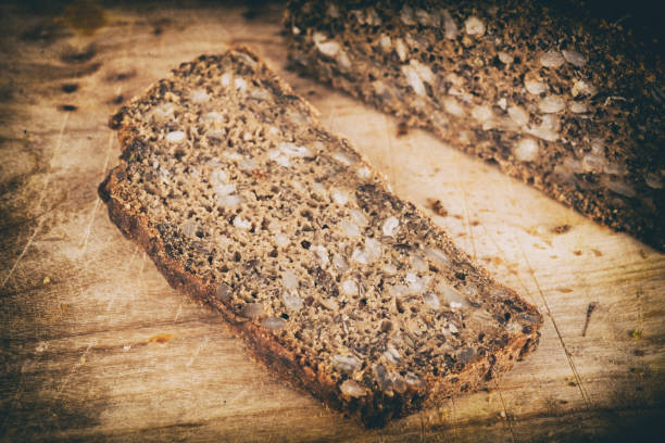 sliced homemade grain bread with knife