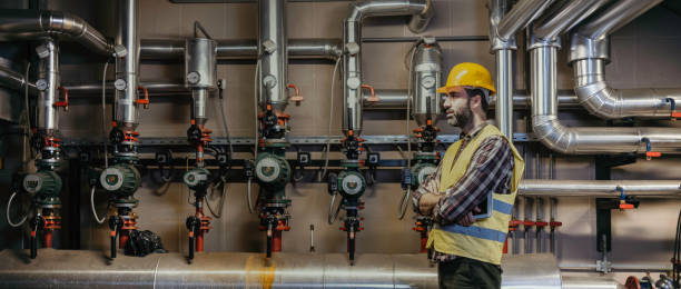 istock Technician engineer man in uniform with tablet checking and control boiler tanks and liquid pipeline in production line at factory 1386001165