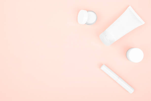 istock on a pink background white cosmetics, hand cream, face cream and lipstick 1386009592