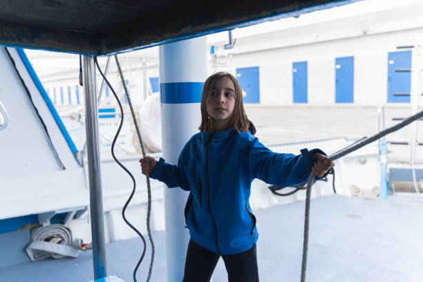 istock Boy holding ropes on a boat 1386009869