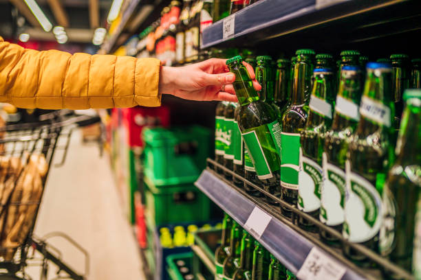 istock Customer buying beer in liquor store 1386010246