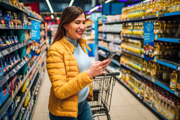 istock Woman checking shopping list on smartphone 1386013493