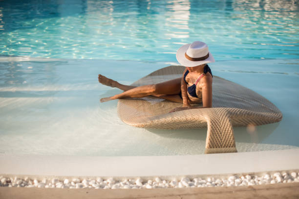 Woman swimming at the luxury poolside stock photo