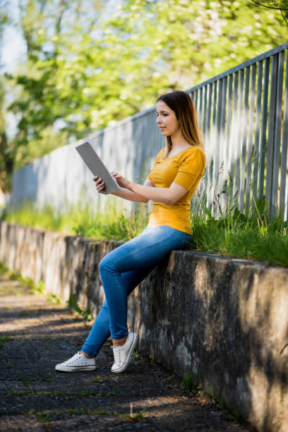 istock women using digital tablet in city 1386025214