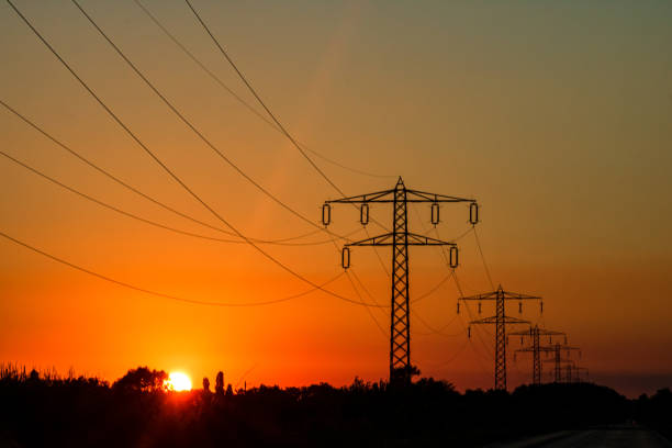 istock Electric power pylon, electric tower at sunset 1386028661