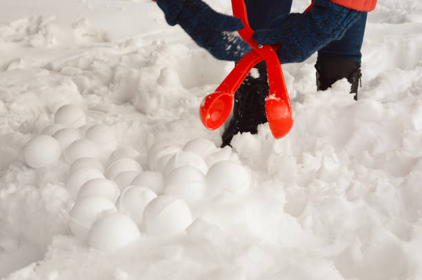 istock fun winter games in the snow, modeling snowballs. 1386029513