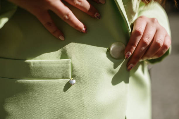 Detail of a woman wearing a green blazer stock photo
