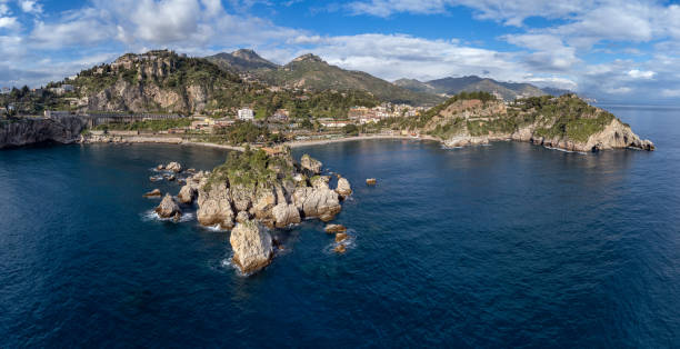 Aerial View. Panoramic drone image of the Gulf of Taormina and Isola Bella - Travel destination, Taormina, Sicily, Italy Aerial View. Panoramic drone image of the Gulf of Taormina and Isola Bella - Travel destination, Taormina, Sicily, Italy isola bella taormina stock pictures, royalty-free photos & images