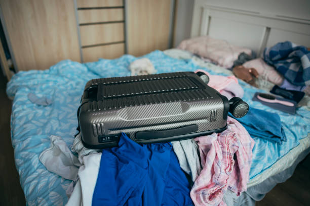 A chaotic scene of piles of clothes and luggage. A chaotic scene of piles of clothes and luggage. temporary stock pictures, royalty-free photos & images