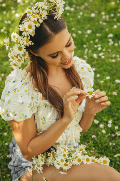 istock Beautiful woman among daisies 1386032119
