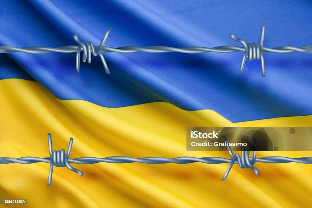 Flag of Ukraine behind barbwire 2022 Stock Photo