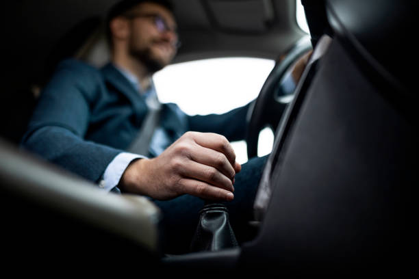 Businessman driving his car Businessman driving his car ,focus on a gear stick gearstick stock pictures, royalty-free photos & images