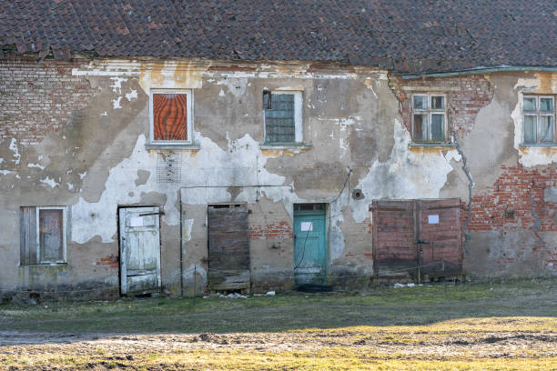 istock Closed doors of old weathered brick wall 1386036113