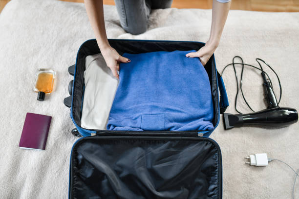 istock Female Making Adequate Space For All Items In Traveling Bag 1386037574