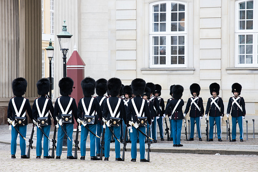 Copenhagen, Denmark - July 1, 2022: Royal guardsmen marching in field dress in Rosenborg slot. Rosenborg is famous castle and museum of Copenhagen.