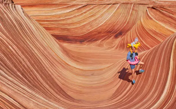 Photo of Father and Toddler Daughter Exploring The Famous Wave of Coyote Buttes North in the Paria Canyon-Vermilion Cliffs Wilderness of the Colorado Plateau in Southern Utah and Northern Arizona USA