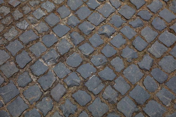 istock Closeup of cobblestone pavement background 1386050627