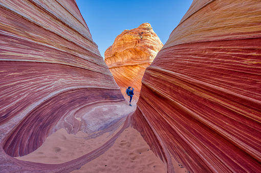 Mother and Daughter Exploring the famous Wave of Coyote Buttes North in the Paria Canyon-Vermilion Cliffs Wilderness of the Colorado Plateau in southern Utah and northern Arizona USA.
