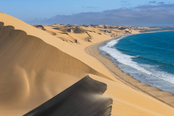 Aerial view of Sandwich Harbour, where the Namib desert meets the Atlantic coast, near Walvis Bay in Namibia, Africa.