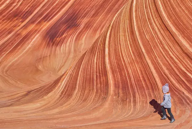 Photo of Toddler Girl Exploring the Famous Wave of Coyote Buttes North in the Paria Canyon-Vermilion Cliffs Wilderness of the Colorado Plateau in Southern Utah and Northern Arizona USA