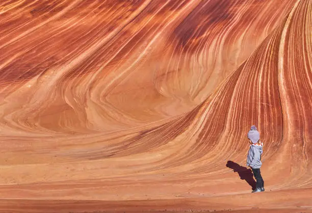 Photo of Toddler Girl Exploring the Famous Wave of Coyote Buttes North in the Paria Canyon-Vermilion Cliffs Wilderness of the Colorado Plateau in Southern Utah and Northern Arizona USA