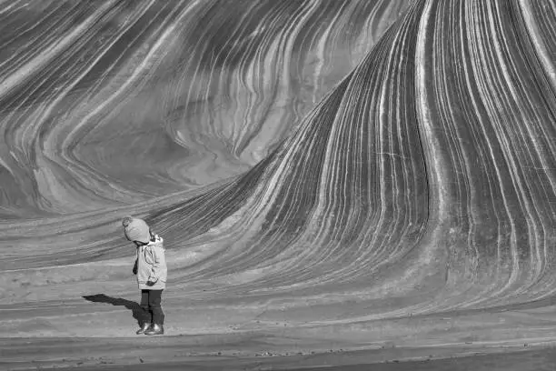 Photo of Toddler Girl Exploring the Famous Wave of Coyote Buttes North in the Paria Canyon-Vermilion Cliffs Wilderness of the Colorado Plateau in Southern Utah and Northern Arizona USA