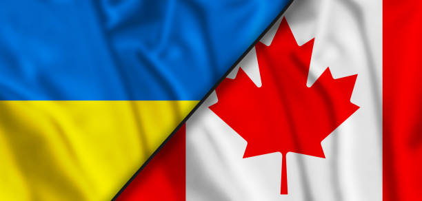 istock Ukraine Flag and Canada flag waving with texture sky Cloud and sunset Double flag 1386056918