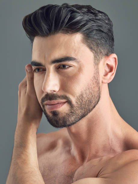 istock Shot of a handsome young man posing against a grey background 1386057146