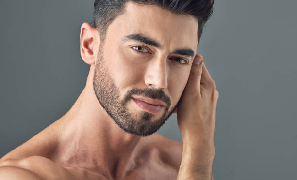 istock Shot of a handsome young man posing against a grey background 1386057149