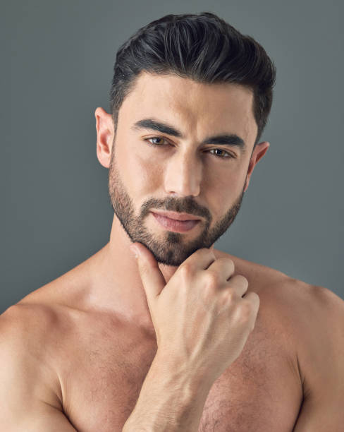 istock Shot of a handsome young man posing against a grey background 1386057150