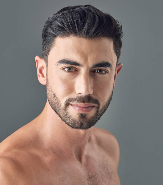 istock Shot of a handsome young man posing against a grey background 1386057155