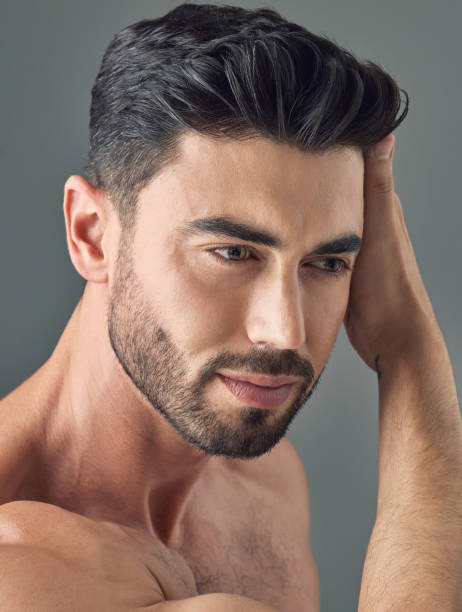 istock Shot of a handsome young man posing against a grey background 1386057156