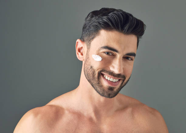 istock Studio shot of a handsome young man posing with moisturiser on his face 1386057184