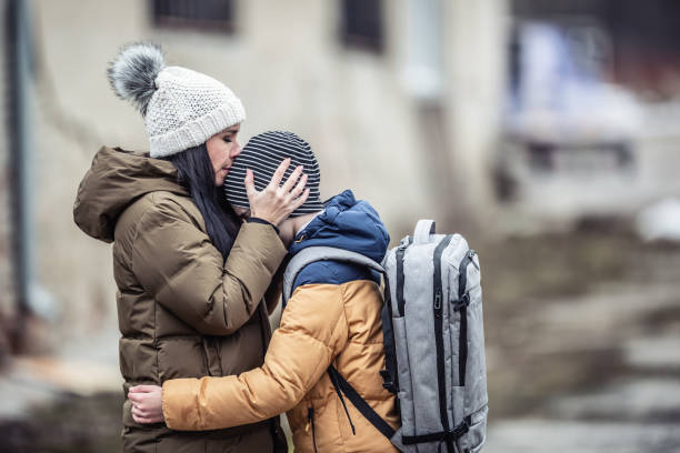 Woman kisses her boy Woman kisses her boy refugee photos stock pictures, royalty-free photos & images