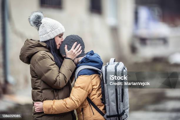 Woman Kisses Her Boy Stock Photo - Download Image Now - Refugee, Child, Accidents and Disasters