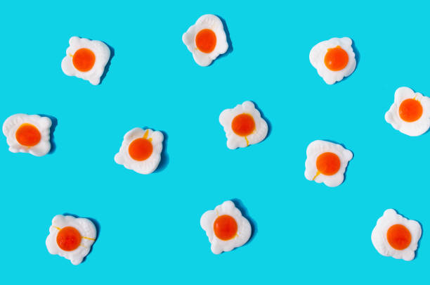 istock A wallpaper or seamless pattern made of scrambled eggs against blue background. Creative concept for background or banner for Easter celebration. Flat lay 1386061427