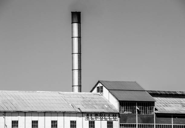 istock Industrial Building with Tall Chimney 1386062310