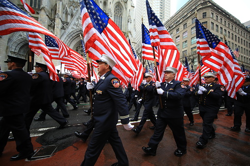 Group of men march way up Madison Avenue, Manhattan  in New York City during the annual Philippine Day Parade.